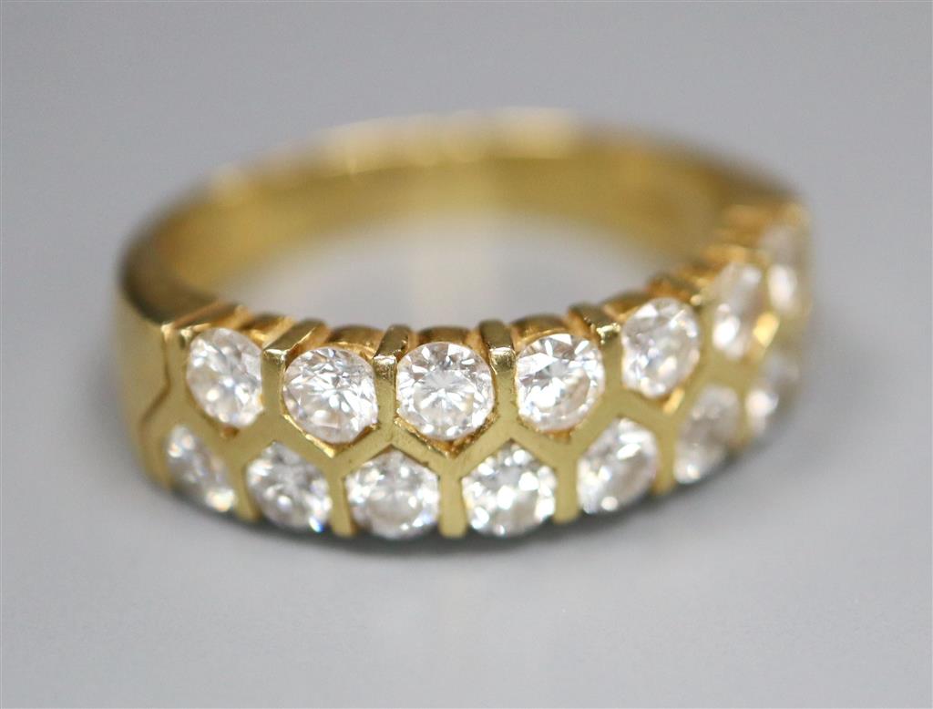 A modern 18ct gold and fifteen stone two row diamond set half hoop ring, size O, gross 6.6 grams.